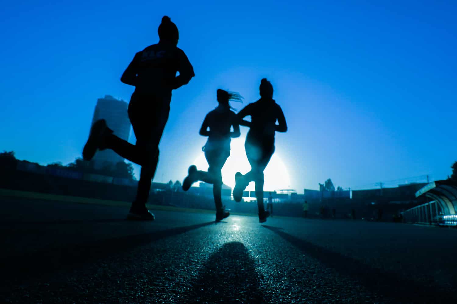 Group of runners at dusk in a city